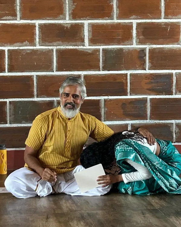 A moment of complete surrender and respect at the feet of my guru. The word 'Guru' means 'dispeller of darkness,' and he has truly illuminated the path of yoga for me.