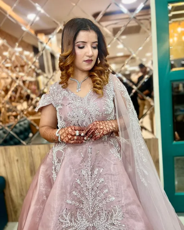 This client is ready for her engagement in a breathtaking dusty pink gown. We created a soft glam makeup look with defined eyes and styled her hair in voluminous curls to match the romantic feel of her outfit.