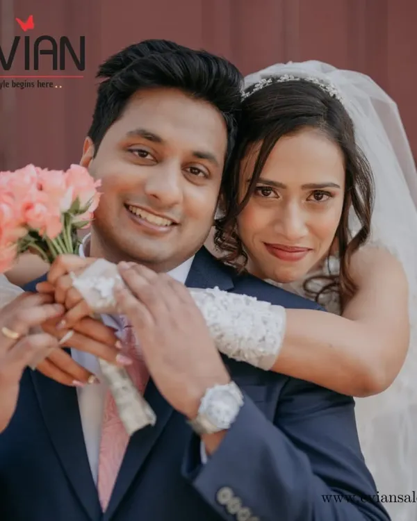 Here's to the happy couple. We created a timeless look for her big day and made sure he looked just as sharp. It's our job to make sure you both shine together on your wedding day.