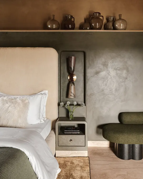 A close-up of a bedroom in the Embassy 821 project, where we layered textures and earthy tones. The lime-washed walls, plush olive green seating, and curated pottery create a calm, Wabi-Sabi inspired atmosphere.