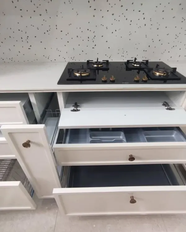 Functionality is key in a modular kitchen. This photo shows the different types of storage I incorporate, including cutlery trays, pull-out drawers, and spice racks, all neatly organized.
