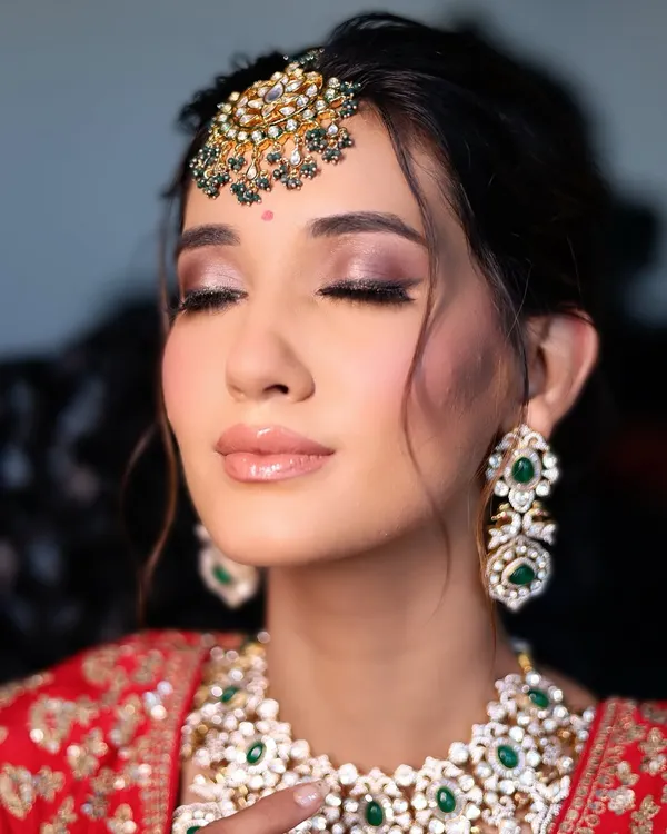 The essence of soft glam. A beautiful close-up showing a perfectly blended smokey eye, glossy nude lip, and radiant skin.