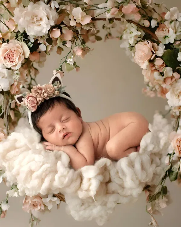 A magical floral swing setup for a sleeping newborn. I use props like this to create dreamy, artistic portraits of your baby girl.