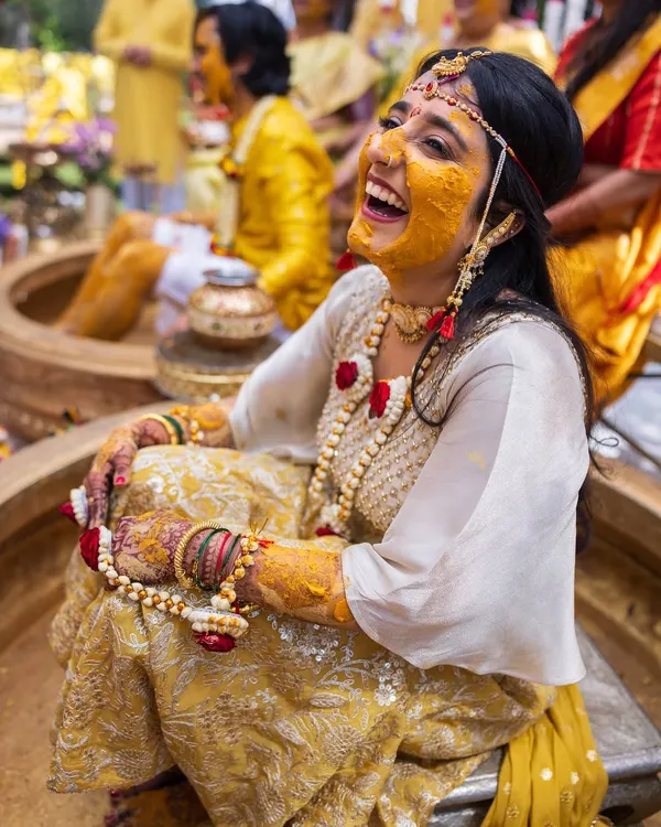 A moment of pure, unadulterated laughter from the bride during her Haldi ceremony. These are the candid shots that truly capture the spirit of the day.