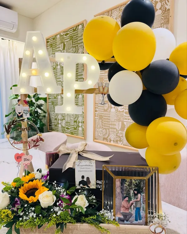 A wedding gift as timeless as their love. This black and gold themed hamper features the couple's light-up initials, a framed photo of their proposal, and a bouquet of sunflowers to symbolize a bright future together.
