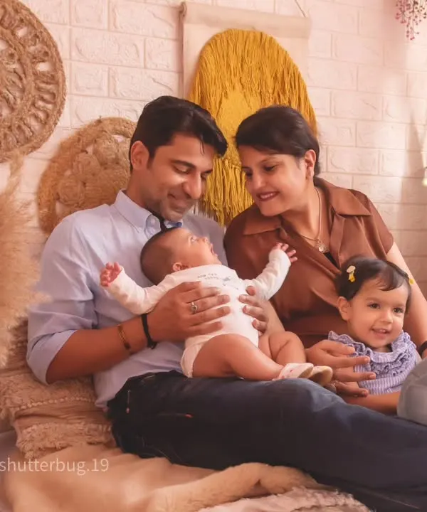 A picture-perfect family portrait in our cozy, boho-themed studio setup, capturing a moment of pure happiness.