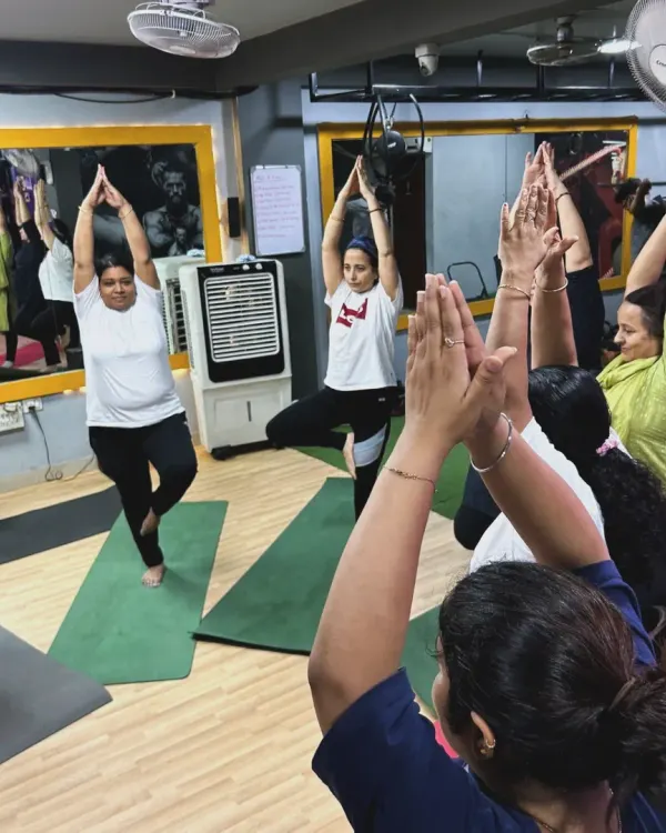 In our studio, we practice Vrikshasana (Tree Pose) together, finding our individual balance while being supported by the group's collective energy. It's a beautiful dance of every cell with the music of every breath.