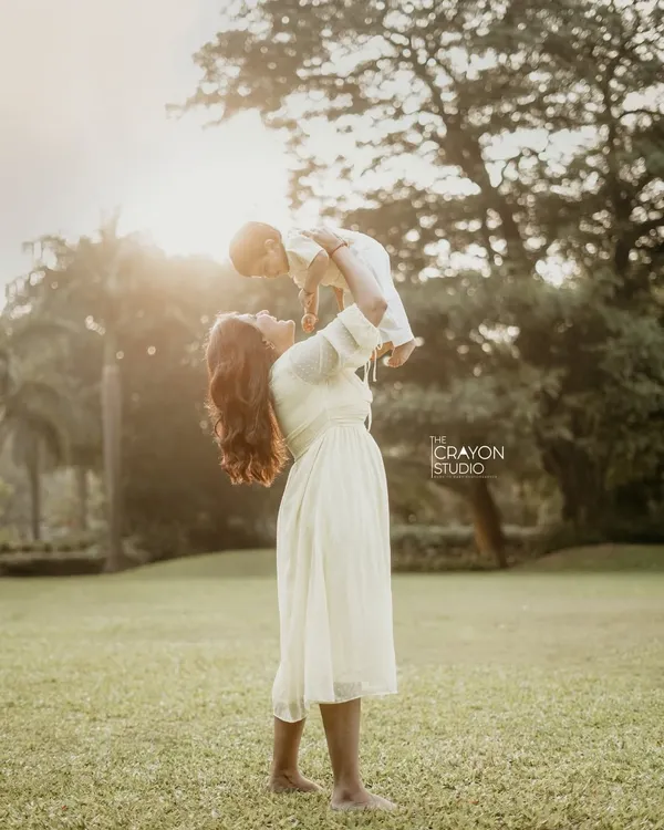 The world seems to stop for a moment when a mother lifts her child to the sky. This is the kind of pure, unfiltered joy I aim to capture during our outdoor family photoshoots, creating a timeless memory bathed in golden light.