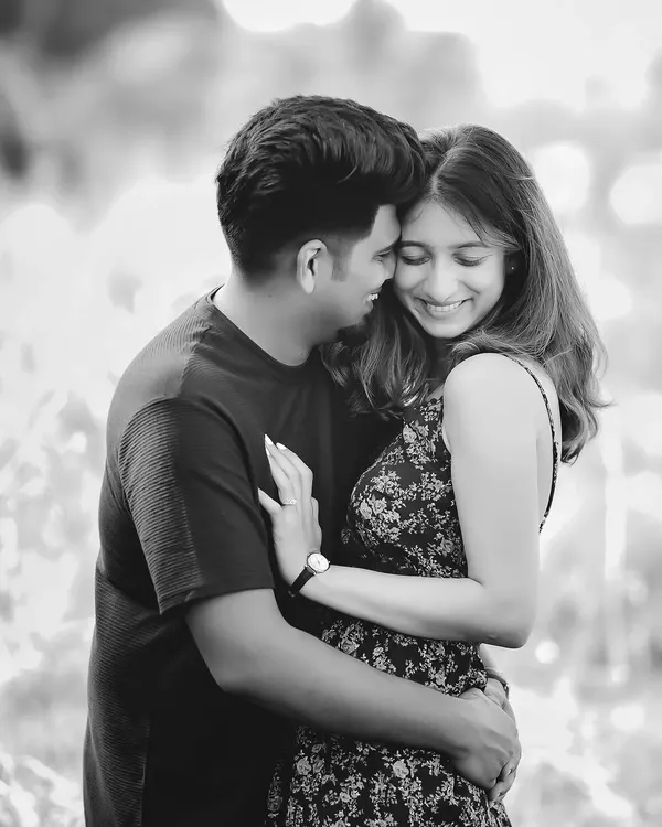 A joyful and candid black and white portrait of Anjali and Platini. Monochrome is perfect for capturing pure emotion and laughter without the distraction of color.
