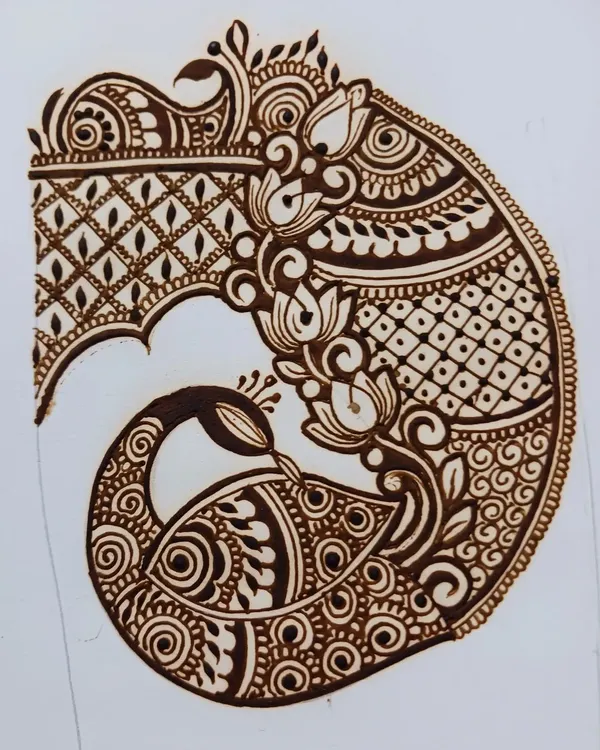 Practicing an intricate peacock startup for a bridal design. Working on paper helps me perfect the flow and details before applying it to a client's hands.