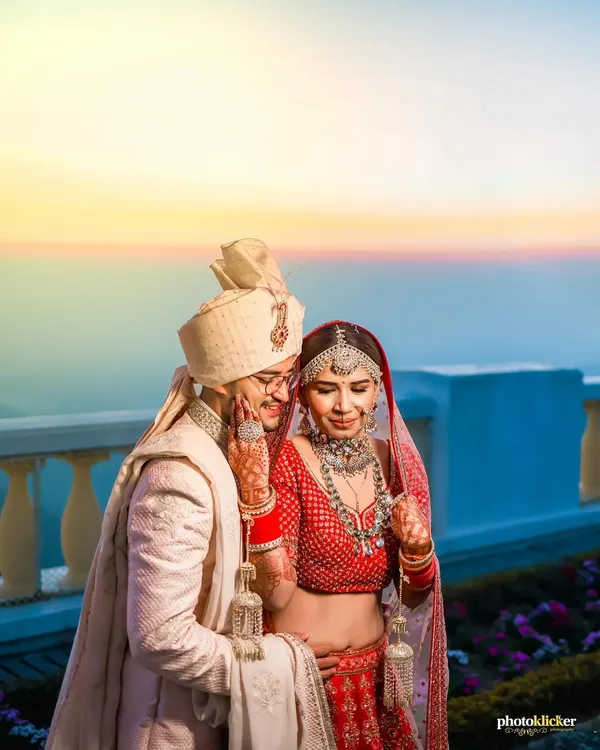 A quiet moment for the couple against a breathtaking sunset in Mussoorie. We specialize in capturing these serene, romantic portraits during destination weddings, creating timeless images that feel like a dream.