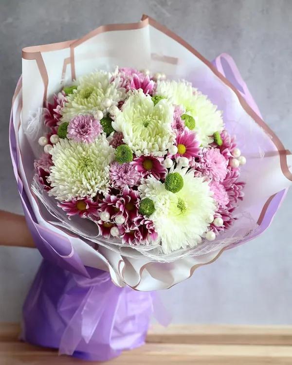 As delicate as a petal and as strong as the fragrance. This beautiful hand-tied bouquet of chrysanthemums is a perfect gift for the strong women in your life.