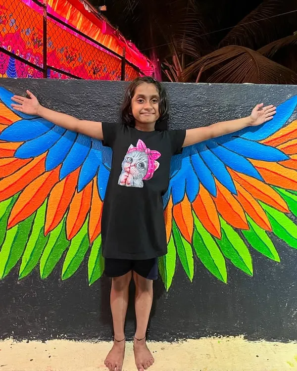 This interactive angel wing mural brings joy to people of all ages, creating a perfect photo opportunity. It's one of my most requested pieces for public spaces and cafes.