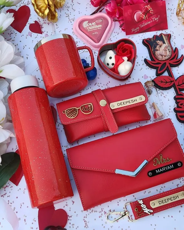 This premium Valentine's hamper in sparkling red is the ultimate gift of love. It includes a personalized sparkle flask and mug, a custom wallet and eyewear case, a photo rose stick, and other romantic goodies.