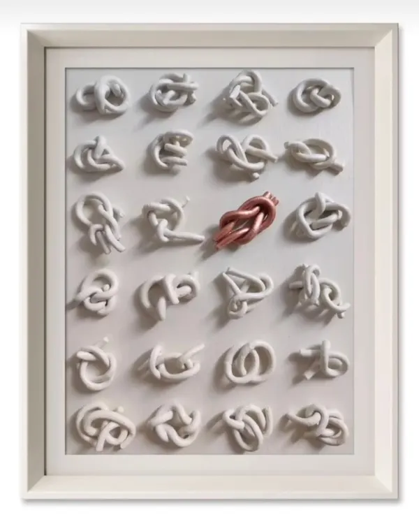 This is my artwork titled 'KNOTS'. Each of the 24 white knots symbolizes a negative trait we might possess. The single copper knot represents the one we are actively working to untie, symbolizing the journey of self-improvement.