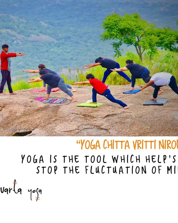 Guiding a group through Virabhadrasana (Warrior Pose) on a rocky plateau. This is an example of "Yoga Chitta Vritti Nirodha", using the physical practice to stop the fluctuations of the mind and find stability.