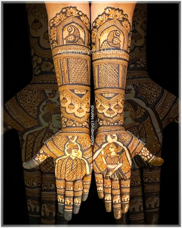 A complete bridal story with portraits of the bride and groom on each palm. The arms are decorated with traditional elements like parrots in jharokhas and personalized name designs, telling a full wedding story.