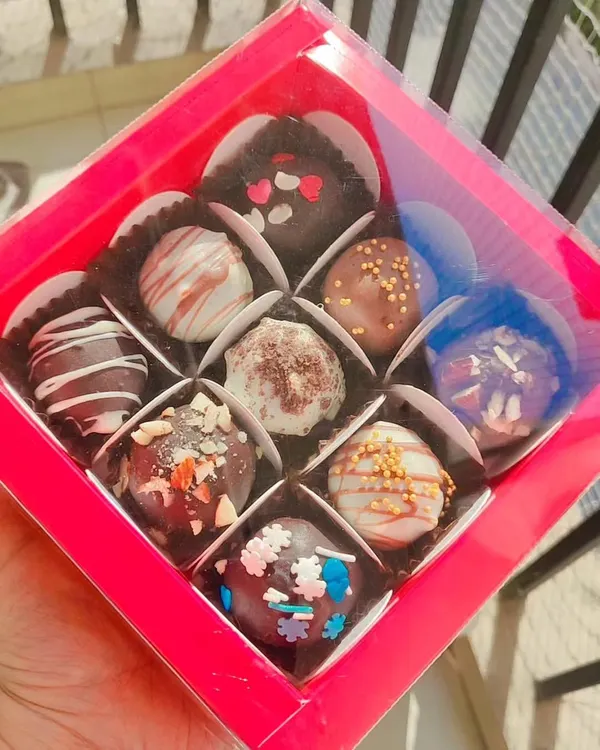 A box of nine of my assorted handmade chocolate truffles. This is a perfect budget-friendly yet delicious gift for any chocolate lover.