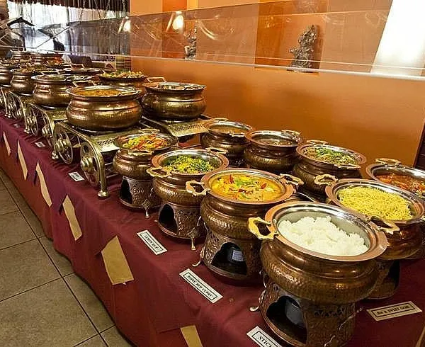 A look at our traditional buffet setup, featuring authentic copper and brass serving dishes. This arrangement is perfect for weddings and cultural events, showcasing a wide array of dishes while keeping them warm for your guests.