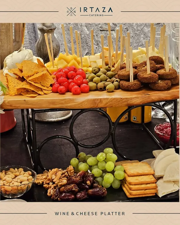 A beautiful grazing platter perfect for a corporate wine and cheese event. The rustic wooden board is laden with cheeses, crackers, nuts, fruits, and olives, creating an abundant and inviting display.