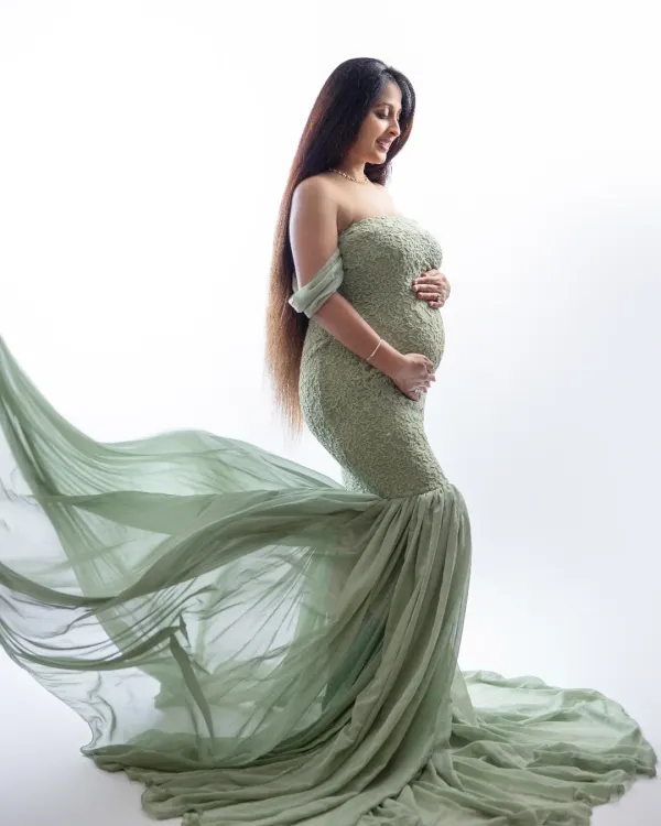 This is the magic we love to create. A beautiful solo portrait celebrating the incredible journey of motherhood in a stunning, flowy green gown against a clean white studio backdrop. We believe every mama deserves to feel like a goddess. ✨