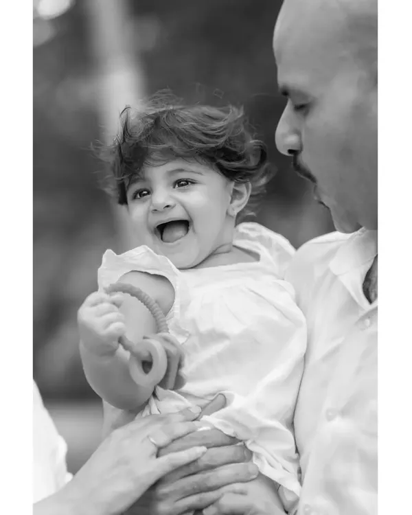 A timeless black and white version of a father and daughter's laugh. Stripping away the color focuses the viewer's attention on the pure emotion and connection in this family portrait.