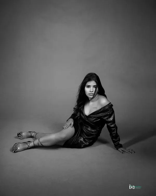 A powerful black and white portrait. The dramatic pose and the stark contrast of the lighting create a strong, emotional image that tells a story of resilience.