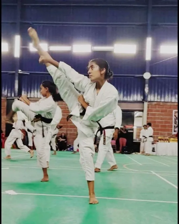One of our dedicated senior students demonstrating a flawless high kick, a result of years of training in flexibility and technique.