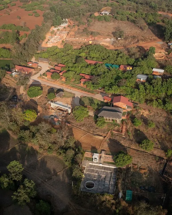 An aerial view of the 14-acre site for the Kaivalyam Yoga Ashram in Belagavi. The master plan is carefully laid out to respect the 120-foot slope and maximize views of the Western Ghats.