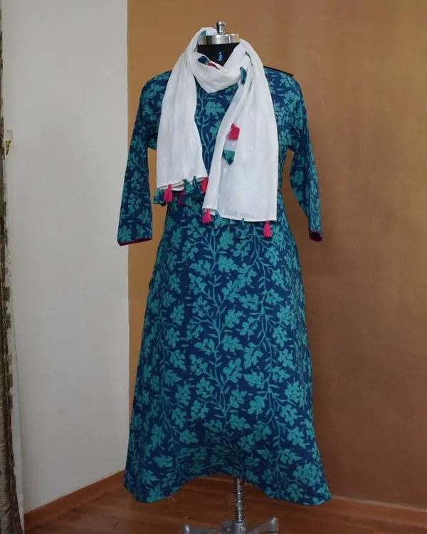 This A-line cotton kurti in shades of blue and turquoise features a lovely floral block print. I've paired it with a simple white dupatta with colorful tassels for a cheerful, everyday look.