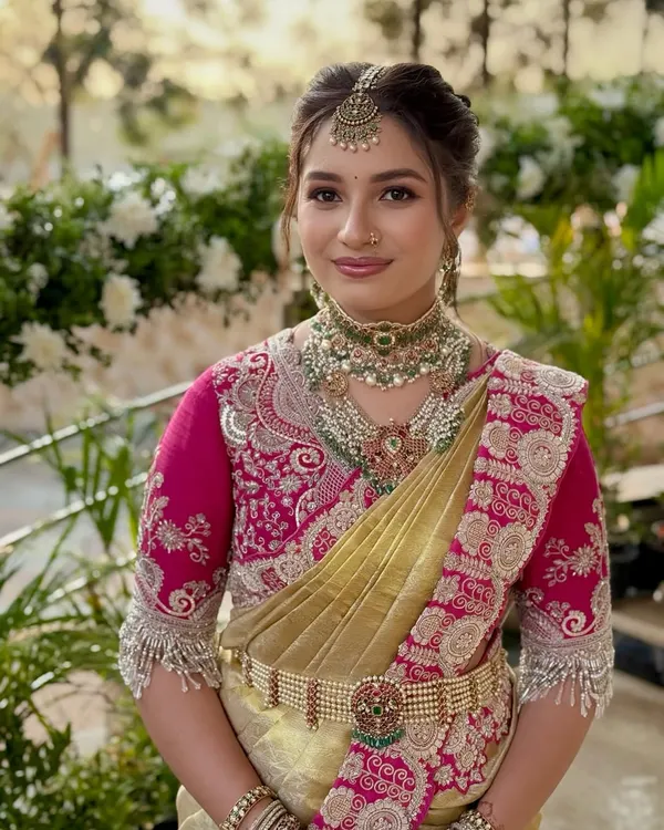 A timeless Muhurtham look for the sister of the bride. The makeup is elegant and traditional, designed to complement the bride's look while allowing her own beauty to shine.