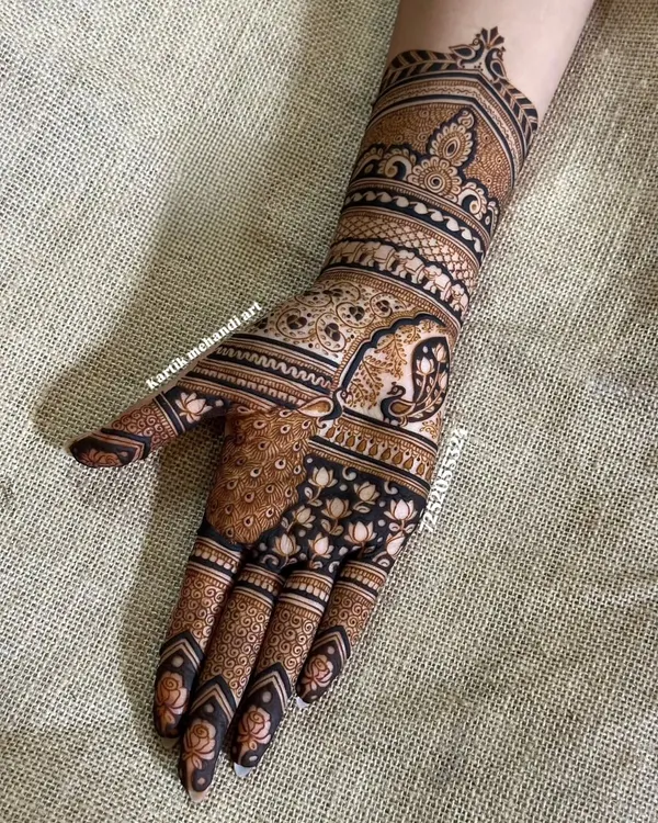 A masterpiece of traditional Indian art, this design features a majestic peacock on the palm and a royal elephant on the wrist, both symbols of grace and prosperity.