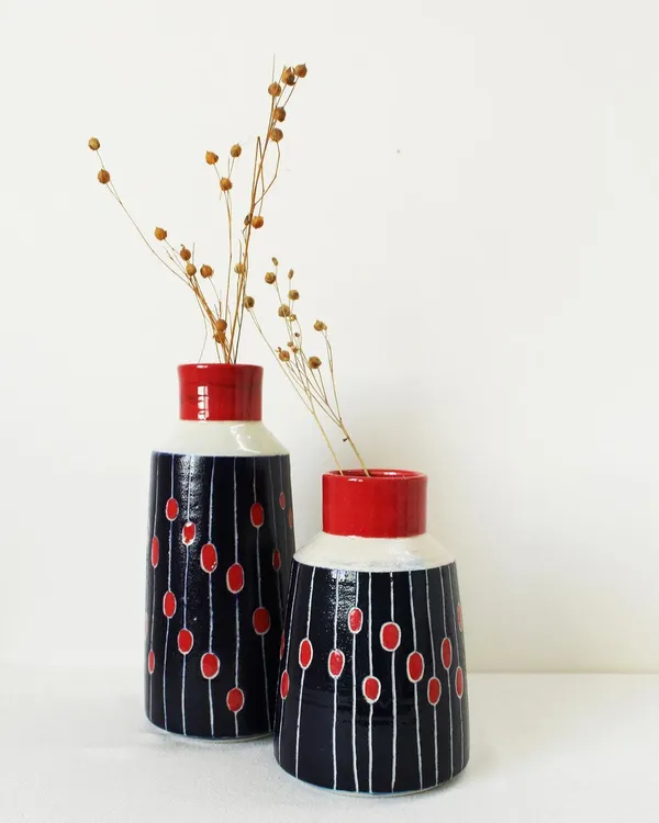 My Dew Drops vases are designed to add a pop of color to any room. This set features a bold pattern of scarlet red and deep indigo, with hand-carved lines adding texture and movement.