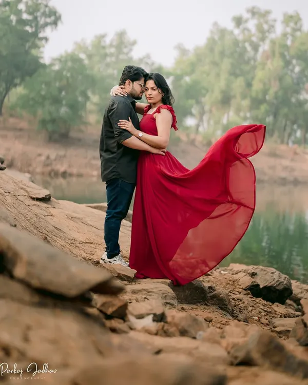 A moment of quiet connection by the water. This pre-wedding shoot with Nutan and Shubham was about capturing the serene and intimate side of their relationship, with her flowing red dress adding a touch of cinematic drama.
