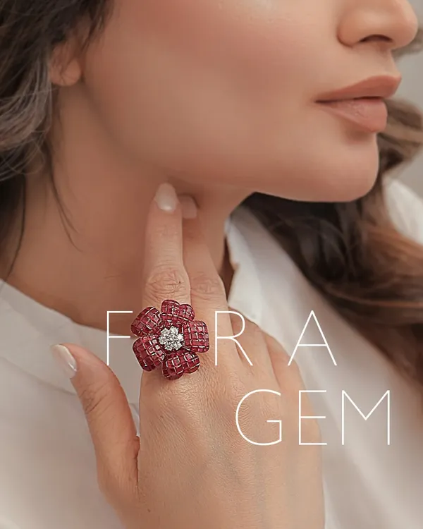 Here is a floral gem ring I designed, worn to showcase its scale and artistry. The piece is crafted from countless tiny rubies to form petals around a center of brilliant diamonds. It is a statement of bold femininity and intricate craftsmanship.