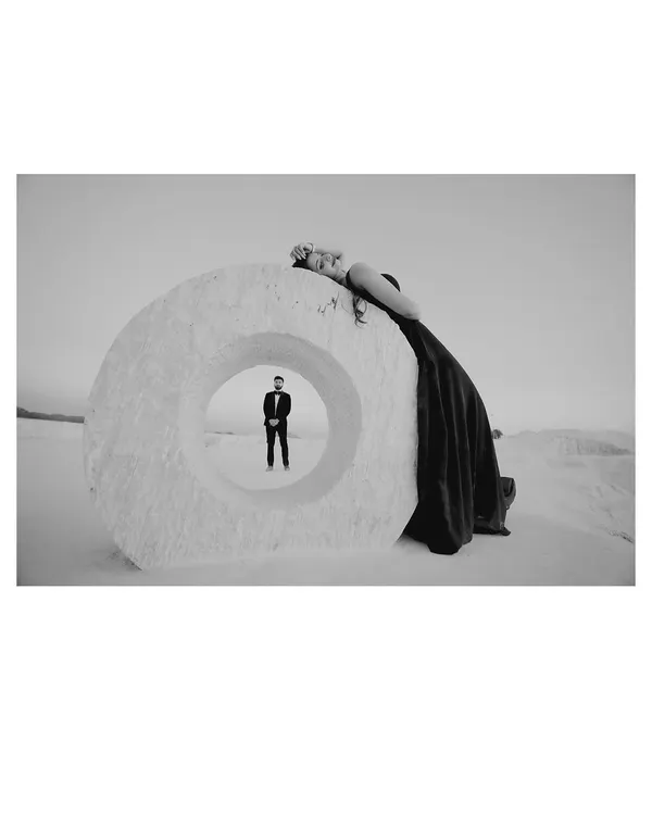 An artistic black and white shot at a mineral quarry, using a large stone ring to frame the groom. This creative composition results in a powerful and memorable image.