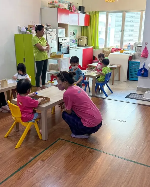 A glimpse into our four-day School Support Program in Miri, Sarawak, Malaysia. Here, a teacher kneels to connect with young children at their level in a classroom at Wonder Stars & Love Fun Kids school. This image embodies the respectful and child-centered guidance we foster.