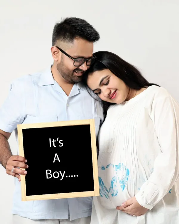 It's a Boy! This couple shares their happy news with a simple chalkboard sign. This is a classic and heartfelt way to announce your baby's gender.