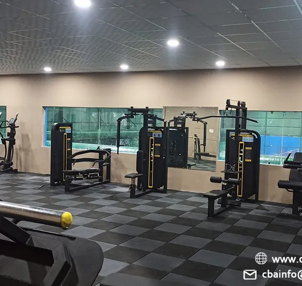 An overview of our on-site gym, featuring a variety of strength and cardio machines. This facility provides a comprehensive fitness solution for our members, allowing them to supplement their on-court training with targeted workouts.