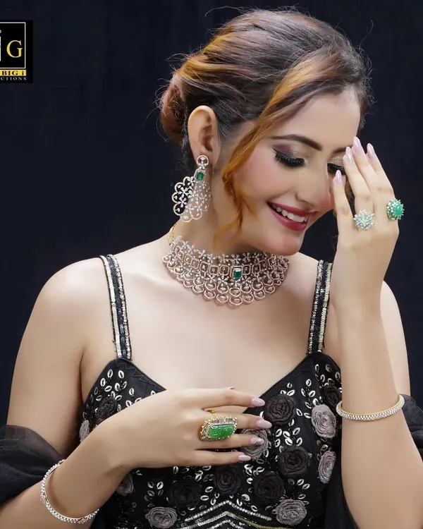 A soft, elegant updo created for a jewelry photoshoot. The hairstyle is designed to complement the diamond choker and earrings without distracting from them.