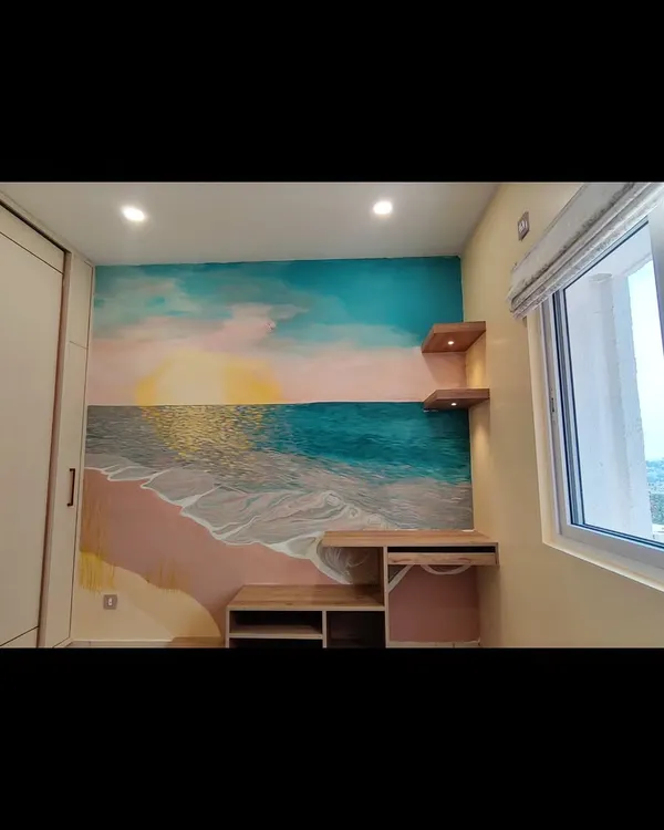 The finished seascape mural in a cozy bedroom. The design is centered around the desk and shelves, making it an integrated part of the room's decor.