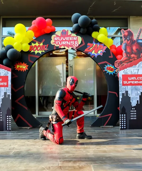 A grand entrance for a superhero. A Deadpool mascot greets guests at this action-packed party entrance, setting the stage for an epic celebration.