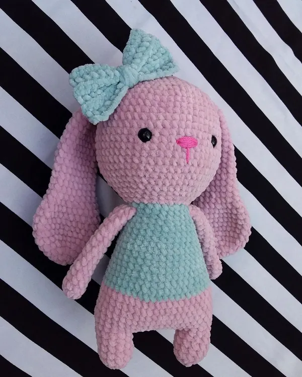 This super soft bunny was a custom order, made with plush pink and mint green yarn. The big bow on her head adds an extra touch of cuteness.