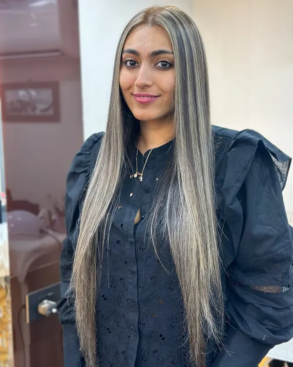 A stunning ash highlights hair color transformation on super long hair. The cool tones are blended perfectly.