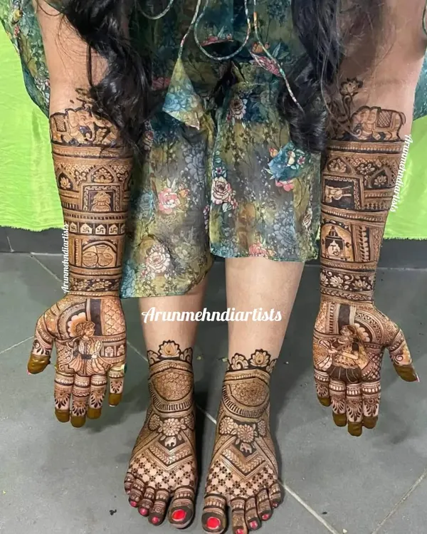 This is a complete bridal mehndi set. The intricate designs on the hands, featuring elephants and architecture, are perfectly complemented by the matching patterns on the feet.