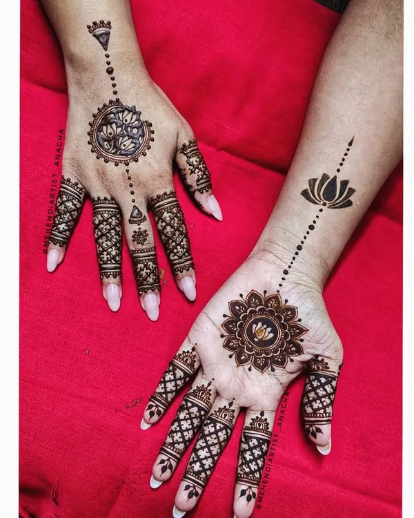 A beautiful mandala design. The pattern is different on each hand, creating a unique and modern look with lotus motifs and geometric finger details.