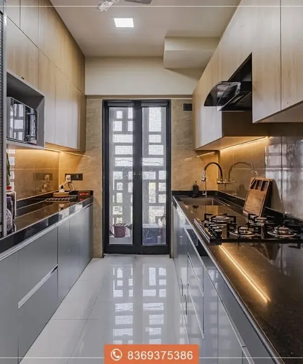 This parallel kitchen layout is a masterclass in efficiency and style. We used a combination of light wood-look upper cabinets and sleek grey lower cabinets, illuminated by continuous under-cabinet LED lighting for a dramatic, modern effect.