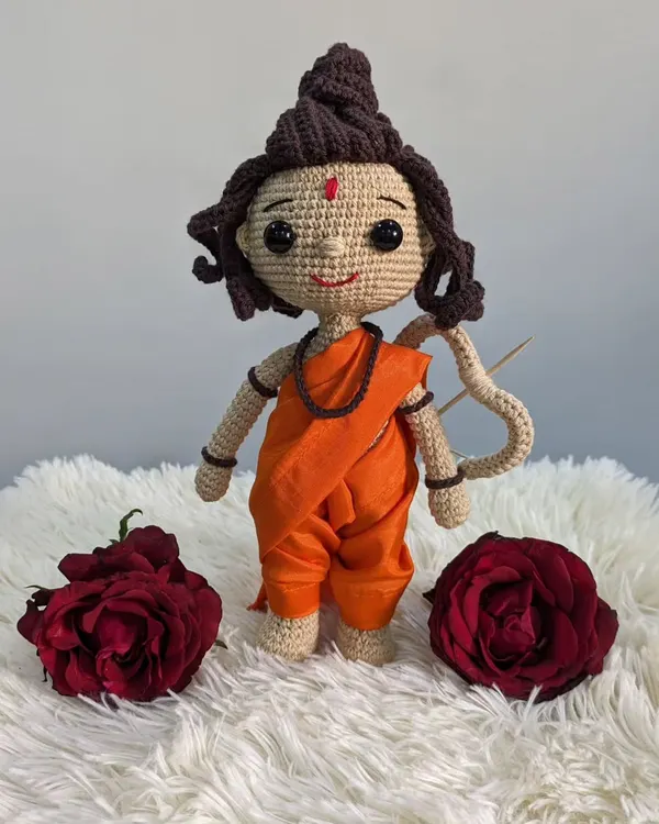A full-length view of my handmade Shree Ram doll, crafted with saffron-colored robes and holding a bow.
