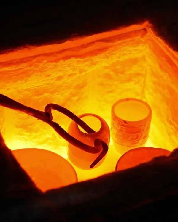 This is the moment of transformation. Inside the kiln, intense heat turns soft clay into lasting ceramic. This raw, fiery process is at the heart of everything we do here.