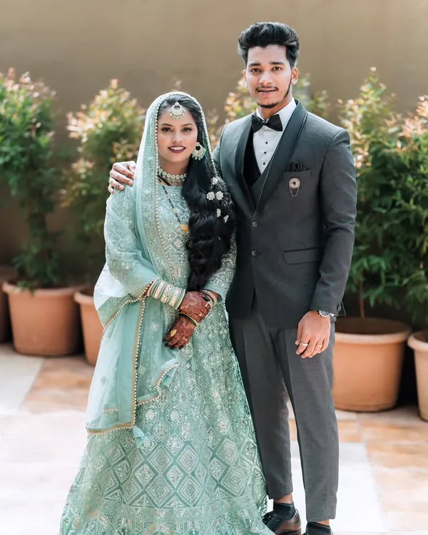 A classic portrait of a bride and groom from a Muslim wedding, showcasing their elegant reception attire.